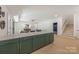 Open concept kitchen features a large island with seating and modern green cabinetry with gold hardware at 626 Concord Rd, Davidson, NC 28036