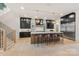 Gourmet kitchen with black cabinets, stainless steel appliances, and an expansive island with seating at 626 Concord Rd, Davidson, NC 28036