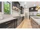 High-end kitchen with modern lighting, granite counters, custom cabinets, and stainless steel appliances at 626 Concord Rd, Davidson, NC 28036