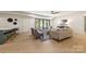 Open concept living space with modern furniture, light wood flooring, and sliding glass doors to the patio at 626 Concord Rd, Davidson, NC 28036