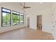 Spacious main bedroom with large windows, hardwood floors, and an en-suite bathroom at 626 Concord Rd, Davidson, NC 28036