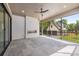 Covered patio with stone flooring, an outdoor fireplace, and a view of the backyard and additional structure at 626 Concord Rd, Davidson, NC 28036