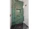 Modern shower featuring stylish green tiling, glass doors, and brass fixtures for a luxurious feel at 626 Concord Rd, Davidson, NC 28036