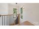 Staircase with iron railings and wood accents, featuring large windows that provide natural light at 626 Concord Rd, Davidson, NC 28036