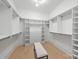 Spacious walk-in closet featuring custom shelving and a comfortable bench for added convenience at 626 Concord Rd, Davidson, NC 28036