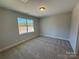 Bright bedroom featuring carpeted floors and a large window at 5031 Mclaughlin Loop # 60, Waxhaw, NC 28173