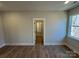 Spacious bedroom with hardwood floors and access to hallway at 5031 Mclaughlin Loop # 60, Waxhaw, NC 28173