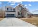 Two-story home with stone accents and a driveway at 5031 Mclaughlin Loop # 60, Waxhaw, NC 28173