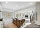 Open concept kitchen island with white quartz countertops and stainless steel sink at 5031 Mclaughlin Loop # 60, Waxhaw, NC 28173