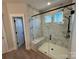 Spacious walk-in shower with marble tile and built-in seat at 5031 Mclaughlin Loop # 60, Waxhaw, NC 28173