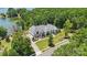 Breathtaking aerial view showcasing a luxury waterfront property surrounded by lush greenery at 18304 Rosapenny Rd, Charlotte, NC 28278