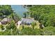 Stunning aerial shot showcasing a luxury home with lakeside access and boat dock at 18304 Rosapenny Rd, Charlotte, NC 28278