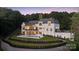 Luxurious backyard with a pristine pool, manicured lawn, and patio, surrounded by lush landscaping providing utmost privacy at 18304 Rosapenny Rd, Charlotte, NC 28278