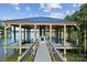Well-maintained boat dock on a tranquil lake, equipped with boat lifts and wooden supports for waterfront recreation at 18304 Rosapenny Rd, Charlotte, NC 28278