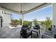 Spacious covered patio with comfortable seating, ceiling fans, and serene lake views, perfect for outdoor entertaining and relaxation at 18304 Rosapenny Rd, Charlotte, NC 28278