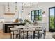 Elegant dining area with modern light fixtures, a marble table, and easy access to the well-equipped kitchen at 18304 Rosapenny Rd, Charlotte, NC 28278