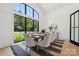 Bright dining room featuring a large window, modern table set, and neutral color palette, creating an elegant dining space at 18304 Rosapenny Rd, Charlotte, NC 28278