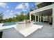 The outdoor space includes a covered patio with a fireplace, built-in grill, and swimming pool at 18304 Rosapenny Rd, Charlotte, NC 28278