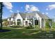 Beautiful new construction with a manicured lawn, detailed landscaping and a welcoming entrance at 18304 Rosapenny Rd, Charlotte, NC 28278