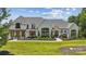 Stunning home with manicured lawn and landscaping and a beautiful stucco exterior with charming architectural details at 18304 Rosapenny Rd, Charlotte, NC 28278