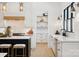 Bright kitchen features white cabinetry, quartz countertops, stainless steel appliances and modern pendant lighting at 18304 Rosapenny Rd, Charlotte, NC 28278