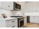 Bright and modern kitchen features stainless steel appliances, white cabinets, and modern countertops at 18304 Rosapenny Rd, Charlotte, NC 28278