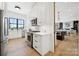 A modern kitchen featuring white cabinets, stainless steel appliances, and hardwood floors at 18304 Rosapenny Rd, Charlotte, NC 28278