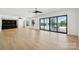 A spacious living room with hardwood floors, a bar area, and large windows with lake views at 18304 Rosapenny Rd, Charlotte, NC 28278