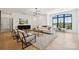 Modern living room with contemporary furnishings, a sleek entertainment center, large windows, and neutral tones throughout at 18304 Rosapenny Rd, Charlotte, NC 28278