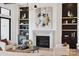 Elegant living room featuring a modern fireplace, stylish decor, and custom built-in shelving at 18304 Rosapenny Rd, Charlotte, NC 28278