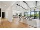 Spacious living area with modern furnishings, an open floor plan, hardwood floors, and large windows showcasing beautiful water views at 18304 Rosapenny Rd, Charlotte, NC 28278