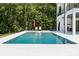 Enjoy this large rectangular swimming pool surrounded by a pristine backyard and lush forest at 18304 Rosapenny Rd, Charlotte, NC 28278