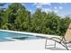 A luxurious backyard pool features a sunbathing area and lounge chairs, perfect for relaxation at 18304 Rosapenny Rd, Charlotte, NC 28278