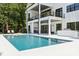 A stunning modern home with a pristine pool, covered patio, and outdoor kitchen at 18304 Rosapenny Rd, Charlotte, NC 28278