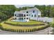 Stunning backyard showcasing a modern pool, covered patio, and beautifully landscaped garden at 18304 Rosapenny Rd, Charlotte, NC 28278