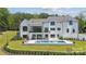 Back exterior view featuring a refreshing pool, multiple patios, and meticulous landscaping at 18304 Rosapenny Rd, Charlotte, NC 28278