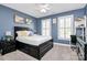 Bedroom with dark-wood bed frame, blue walls, and a desk at 508 Cobbs Glen Ct, Rock Hill, SC 29732