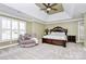 Bright bedroom with carpeted floors, a large bed, and a cozy armchair at 508 Cobbs Glen Ct, Rock Hill, SC 29732