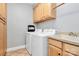 Laundry room with washer, dryer, cabinets, and a utility sink at 508 Cobbs Glen Ct, Rock Hill, SC 29732