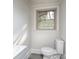 Bathroom with a gray vanity, and a large window at 3119 Hickory Hwy, Statesville, NC 28677