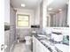Bathroom featuring tiled walls and a black marble counter on a double sink vanity at 3119 Hickory Hwy, Statesville, NC 28677