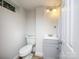 Small bathroom with a toilet, sink, and gray vanity; bright and clean at 3119 Hickory Hwy, Statesville, NC 28677
