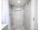 This beautifully tiled walk-in shower has dual shower heads, decorative tiling, and a built-in niche at 3119 Hickory Hwy, Statesville, NC 28677