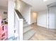 Carpeted stairway and hardwood floors with a well lit landing leading to an open door at 3119 Hickory Hwy, Statesville, NC 28677