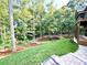 Beautiful backyard with well-maintained lawn, retaining wall and natural landscaping at 859 Tamary Way # 34, Landis, NC 28088