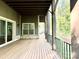 Covered porch with beautiful plank floors, pillars and an exterior light fixture at 859 Tamary Way # 34, Landis, NC 28088
