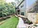 Well-manicured lawn, stone walkway, and verdant trees surround the home's exterior at 859 Tamary Way # 34, Landis, NC 28088
