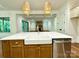 A close-up view of a white kitchen island featuring a white sink, stainless steel dishwasher, and gold hardware at 859 Tamary Way # 34, Landis, NC 28088