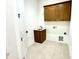 Well-equipped laundry room offering storage cabinets, sink, and convenient in-home laundry amenities at 859 Tamary Way # 34, Landis, NC 28088