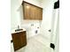 Functional laundry room featuring ample cabinet space, stainless sink, and neutral flooring at 859 Tamary Way # 34, Landis, NC 28088